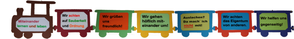 Ein gebastelter Zug mit mit sechs Wagons, in denen das Leitbild der Schule steht.